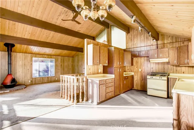 a kitchen with cabinets appliances and a counter