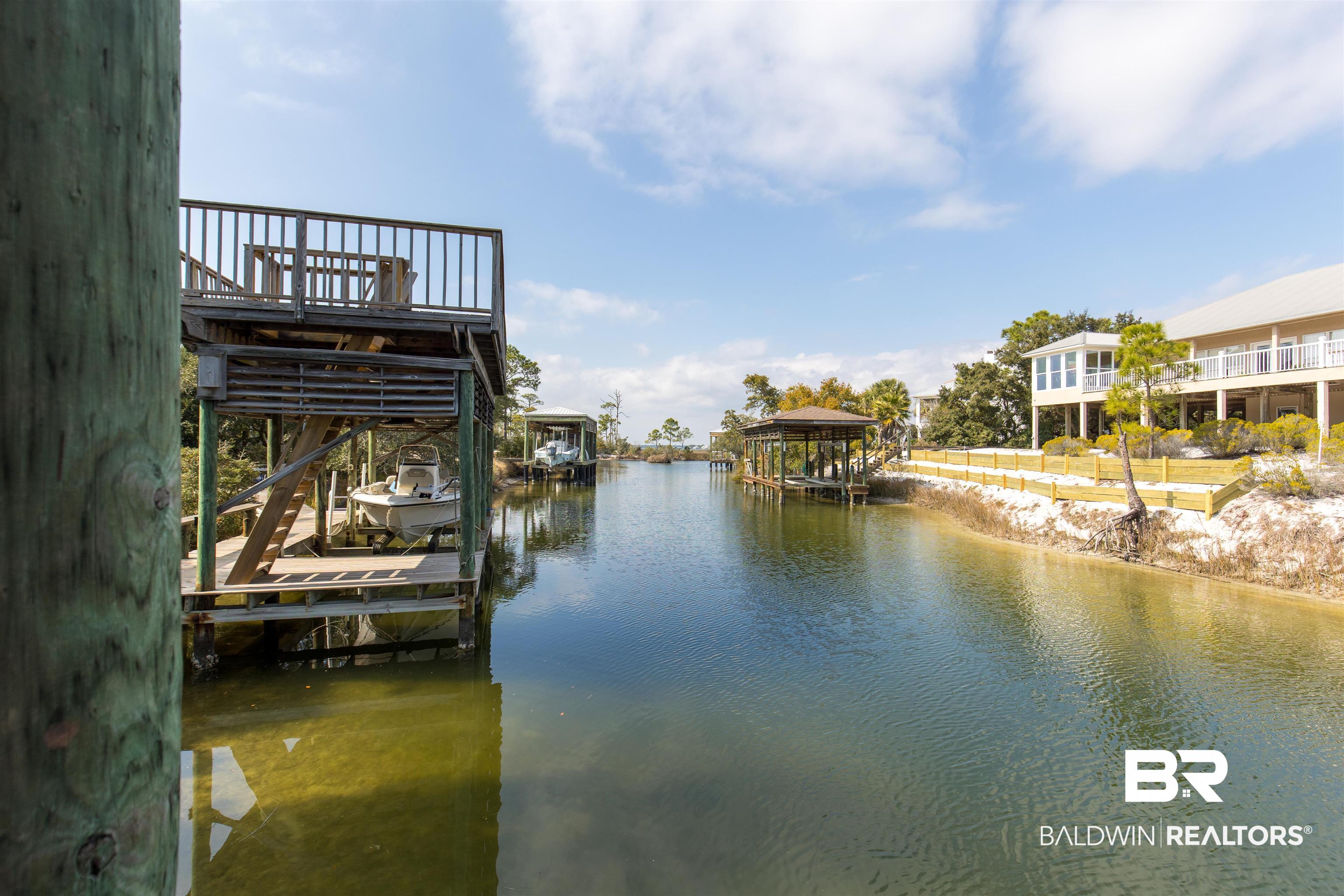 32191 River Road Orange Beach, AL 36561 - Photo 28 of 46 Dock featuring boat lift and a water view