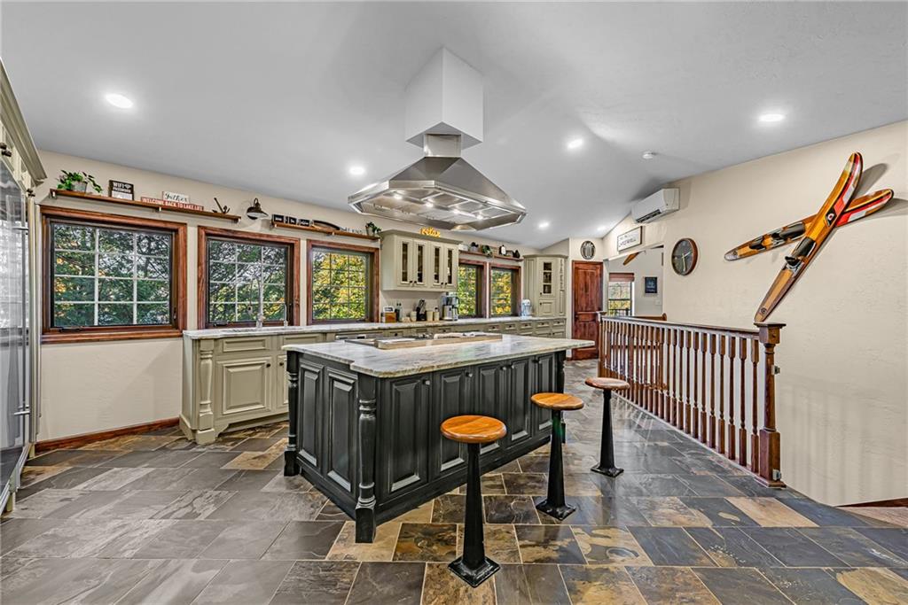 539 Lake Road Addison, PA 15411 - Photo 34 of 43 a kitchen with a stove a refrigerator and chairs