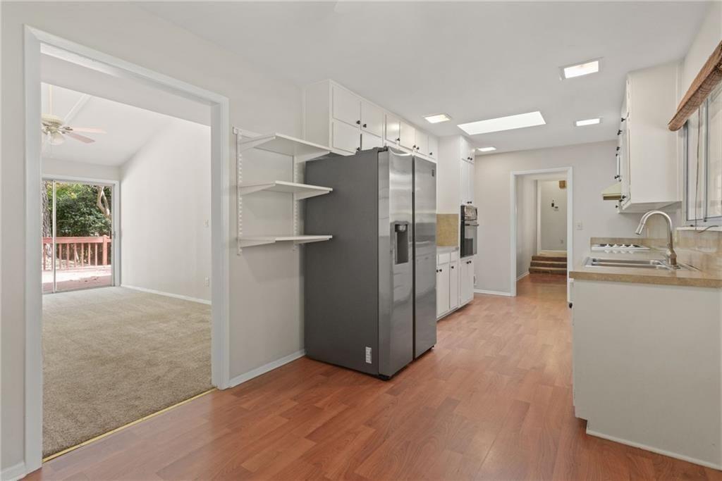 705 Edgewater Trail Sandy Springs, GA 30328 - Photo 17 of 36 a view of a kitchen with a refrigerator and a sink