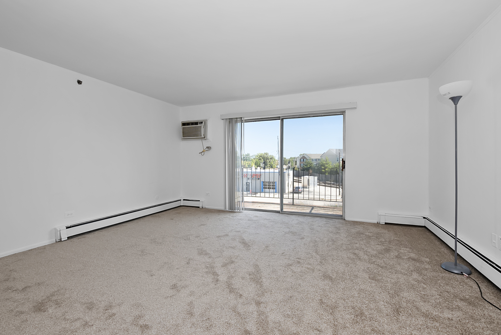 10320 Ridgeland Avenue, Unit 308 Chicago Ridge, IL 60415 - Photo 2 of 16 a view of an empty room with a window