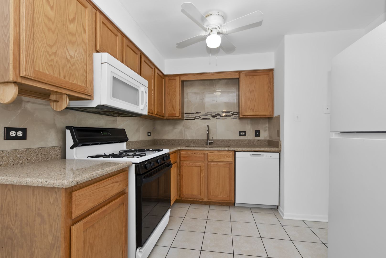 10320 Ridgeland Avenue, Unit 308 Chicago Ridge, IL 60415 - Photo 3 of 16 a kitchen with stainless steel appliances granite countertop a stove a sink and a microwave