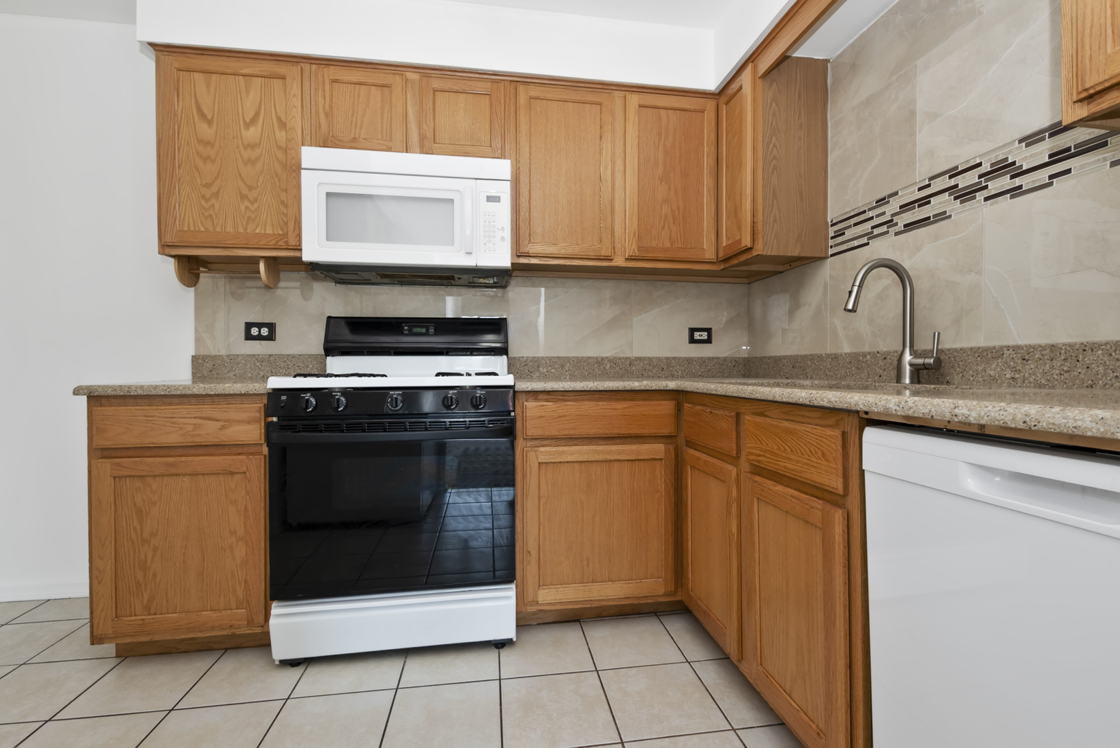 10320 Ridgeland Avenue, Unit 308 Chicago Ridge, IL 60415 - Photo 4 of 16 a kitchen with granite countertop white cabinets and stainless steel appliances