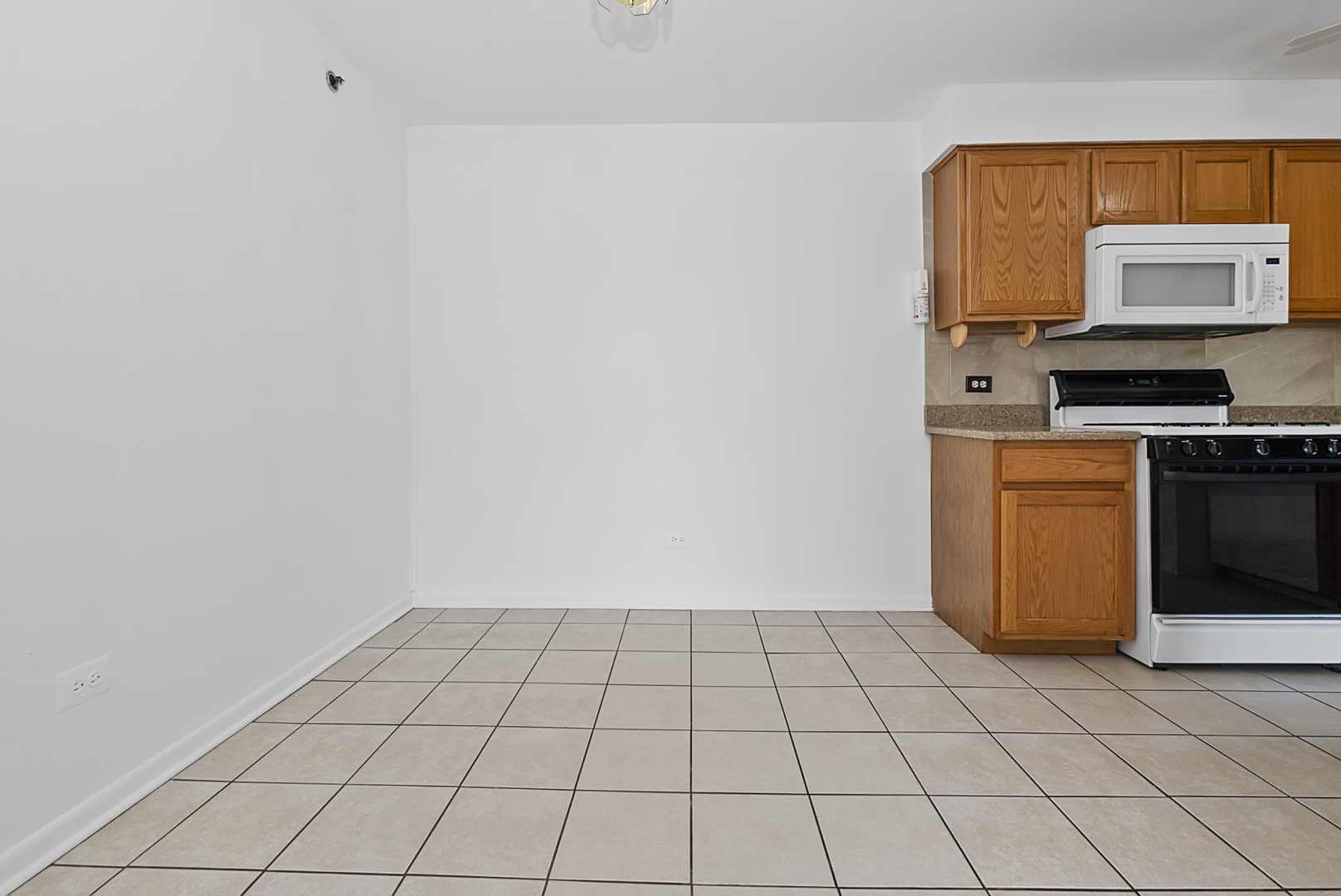 10320 Ridgeland Avenue, Unit 308 Chicago Ridge, IL 60415 - Photo 5 of 16 a view of a kitchen with white cabinets