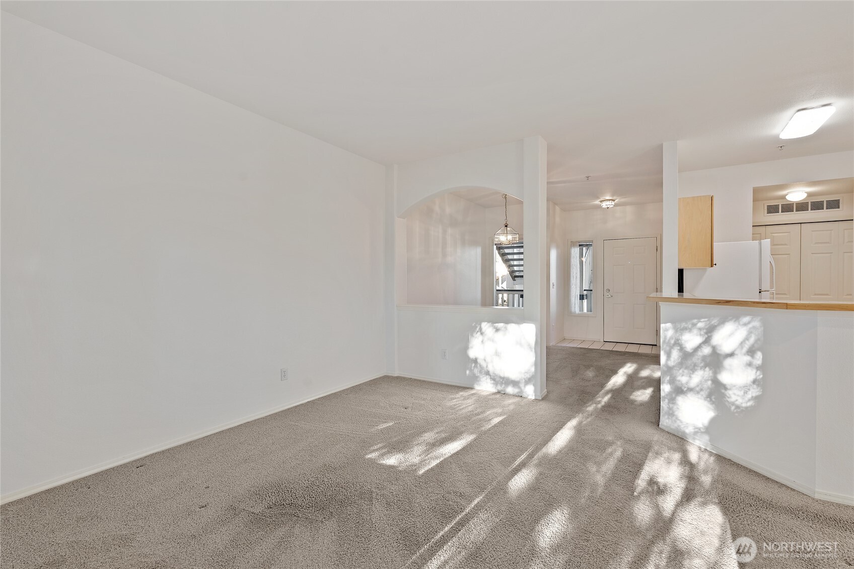 12122 Northeast 171st Place, Unit D201 Bothell, WA 98011 - Photo 21 of 33 a view of a room with wooden floor and windows