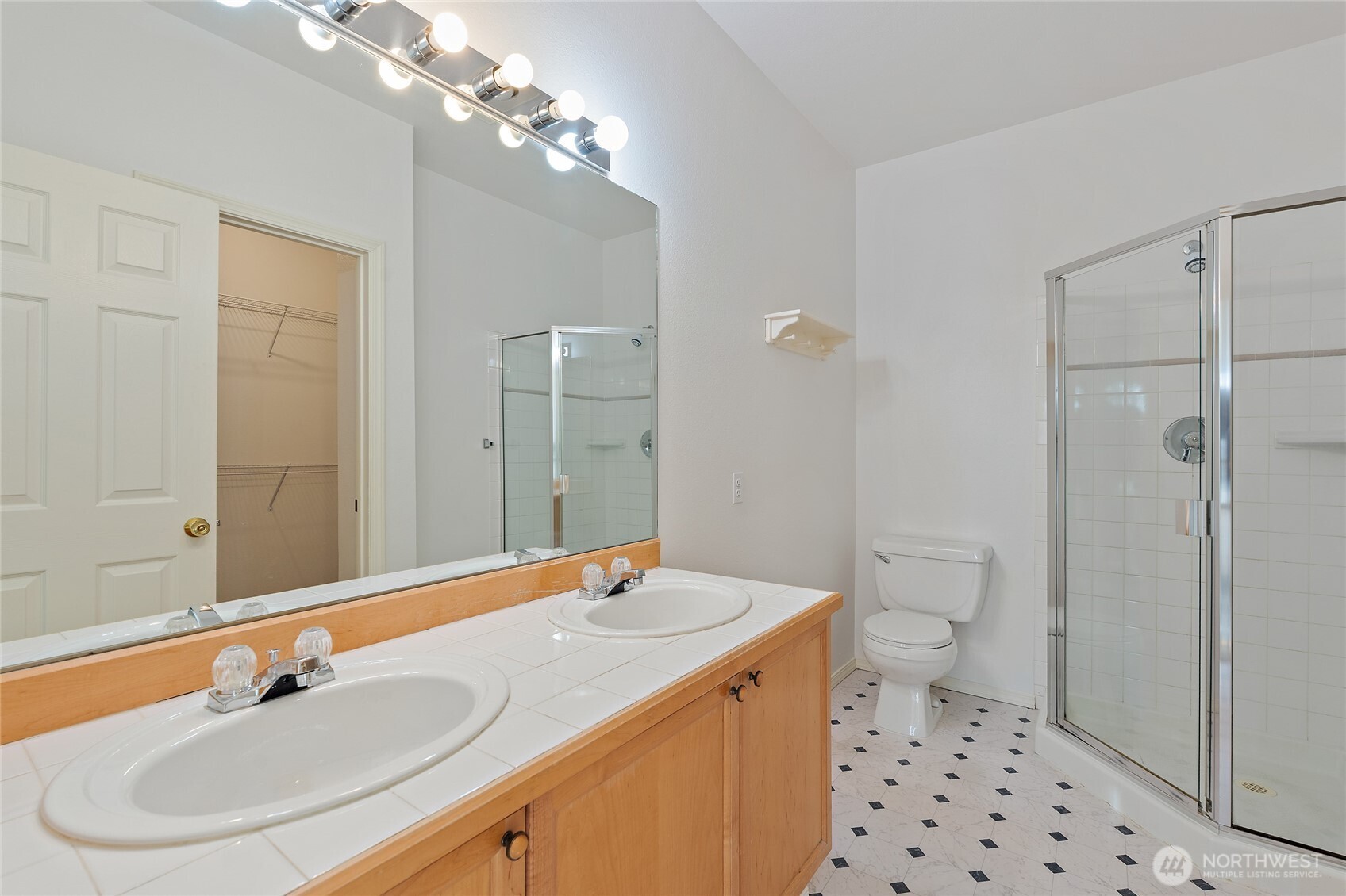 12122 Northeast 171st Place, Unit D201 Bothell, WA 98011 - Photo 24 of 33 a bathroom with a sink a toilet and shower
