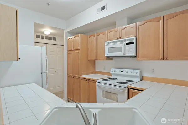a kitchen with stainless steel appliances a cabinets and a stove top oven
