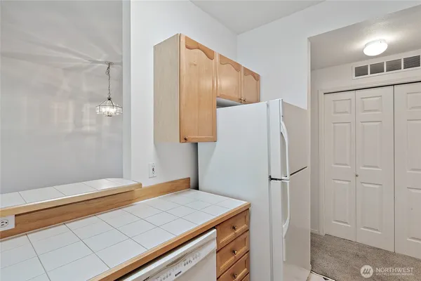 a kitchen with a refrigerator and countertop