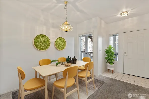 a view of a dining room with furniture and chandelier