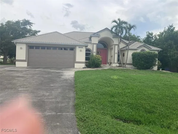 a front view of a house with a yard and garage