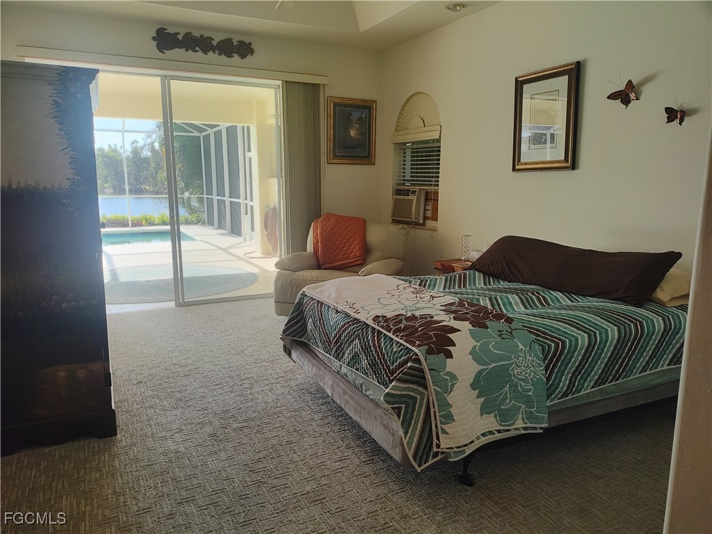 5619 Marina Road Bokeelia, FL 33922 - Photo 11 of 18 a bedroom with a bed lamp and a large window