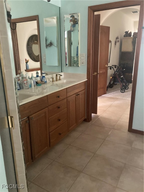 5619 Marina Road Bokeelia, FL 33922 - Photo 12 of 18 a spacious bathroom with a double vanity sink and a mirror