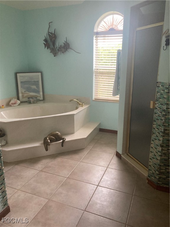 5619 Marina Road Bokeelia, FL 33922 - Photo 14 of 18 a bathroom with a tub and a shower