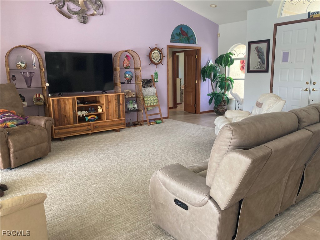 5619 Marina Road Bokeelia, FL 33922 - Photo 5 of 18 a living room with furniture and a flat screen tv