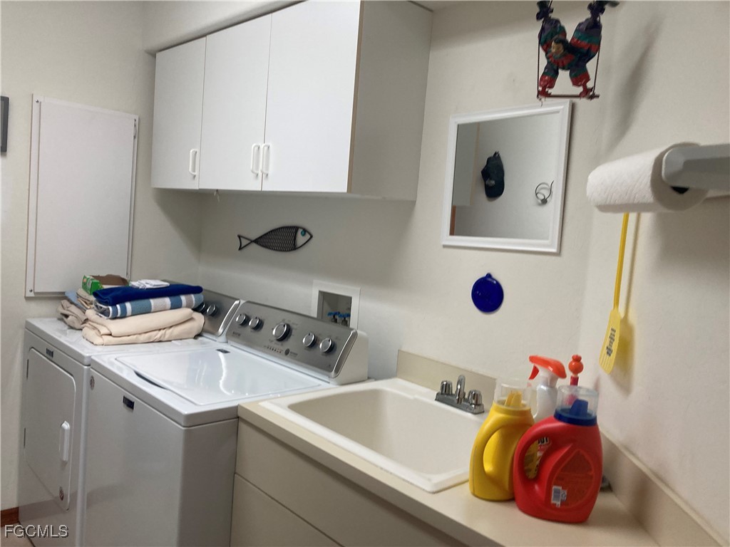 5619 Marina Road Bokeelia, FL 33922 - Photo 9 of 18 a bathroom with a sink and a washing machine