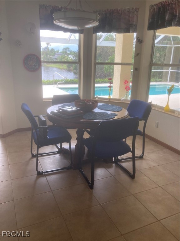 5619 Marina Road Bokeelia, FL 33922 - Photo 10 of 18 a view of a dining room with furniture large windows and wooden floor
