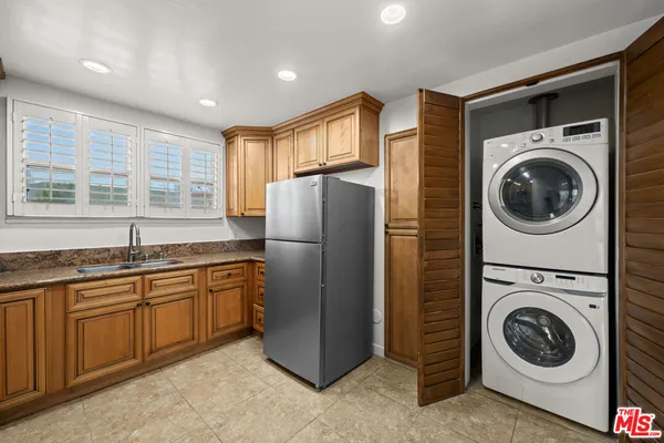 a kitchen with a washer and dryer in it