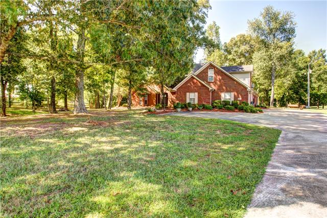 32015 Ardmore Ridge Road Ardmore, TN 38449 - Photo 1 of 19 Front view of home with concrete driveway and turn around, beautifully landscaped with large trees in front yard!