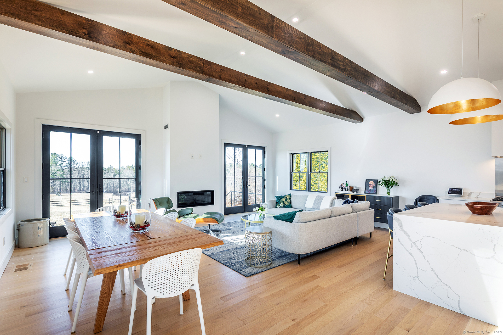 a living room with fireplace furniture and a large window