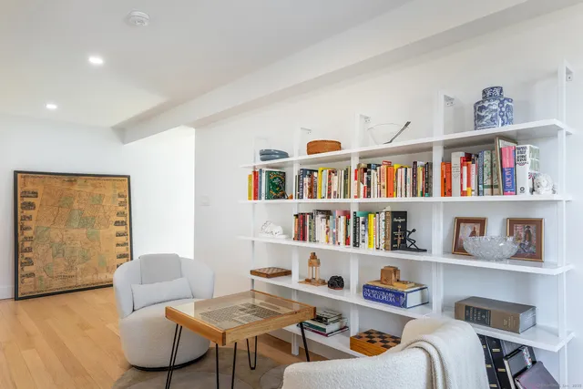 a living room with lots of furniture and a book shelf