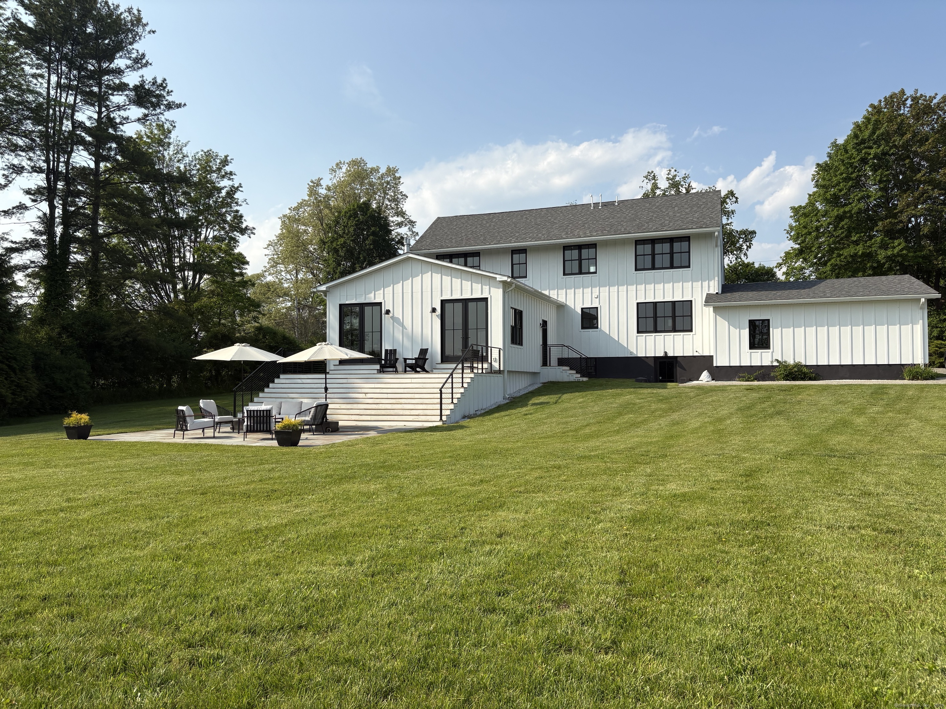 323 Wells Hill Road Salisbury, CT 06039 - Photo 2 of 31 a view of a house with a big yard potted plants and large tree