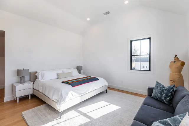 a bedroom with a bed and window