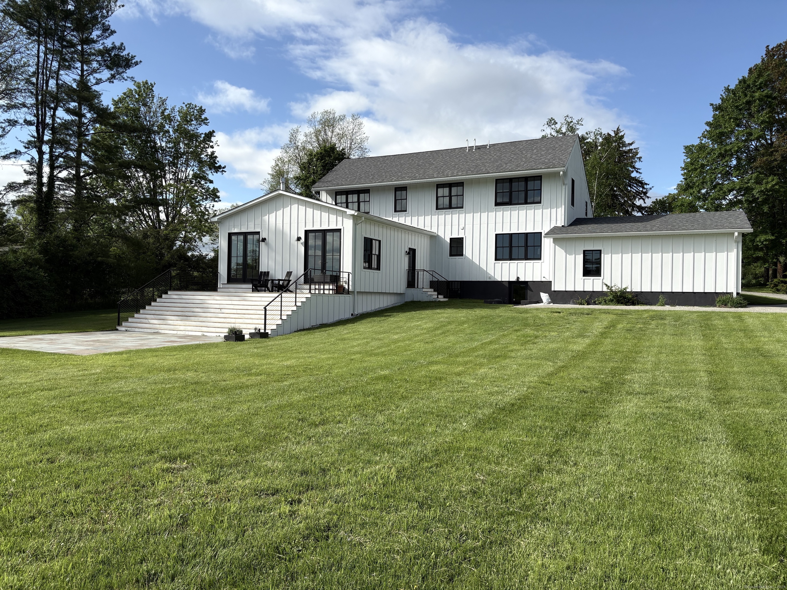 323 Wells Hill Road Salisbury, CT 06039 - Photo 28 of 31 a front view of a house with a yard and trees