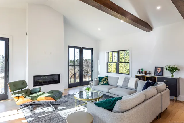 a living room with furniture fireplace and flat screen tv