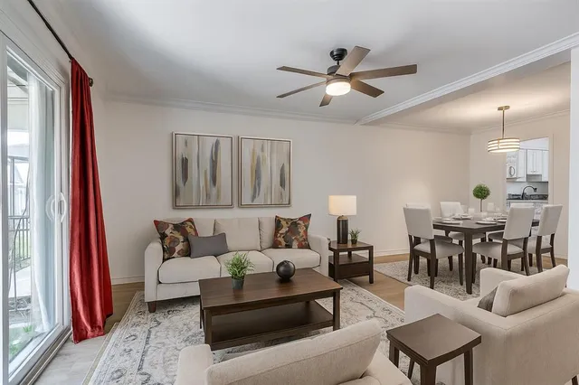 a living room with furniture and a chandelier