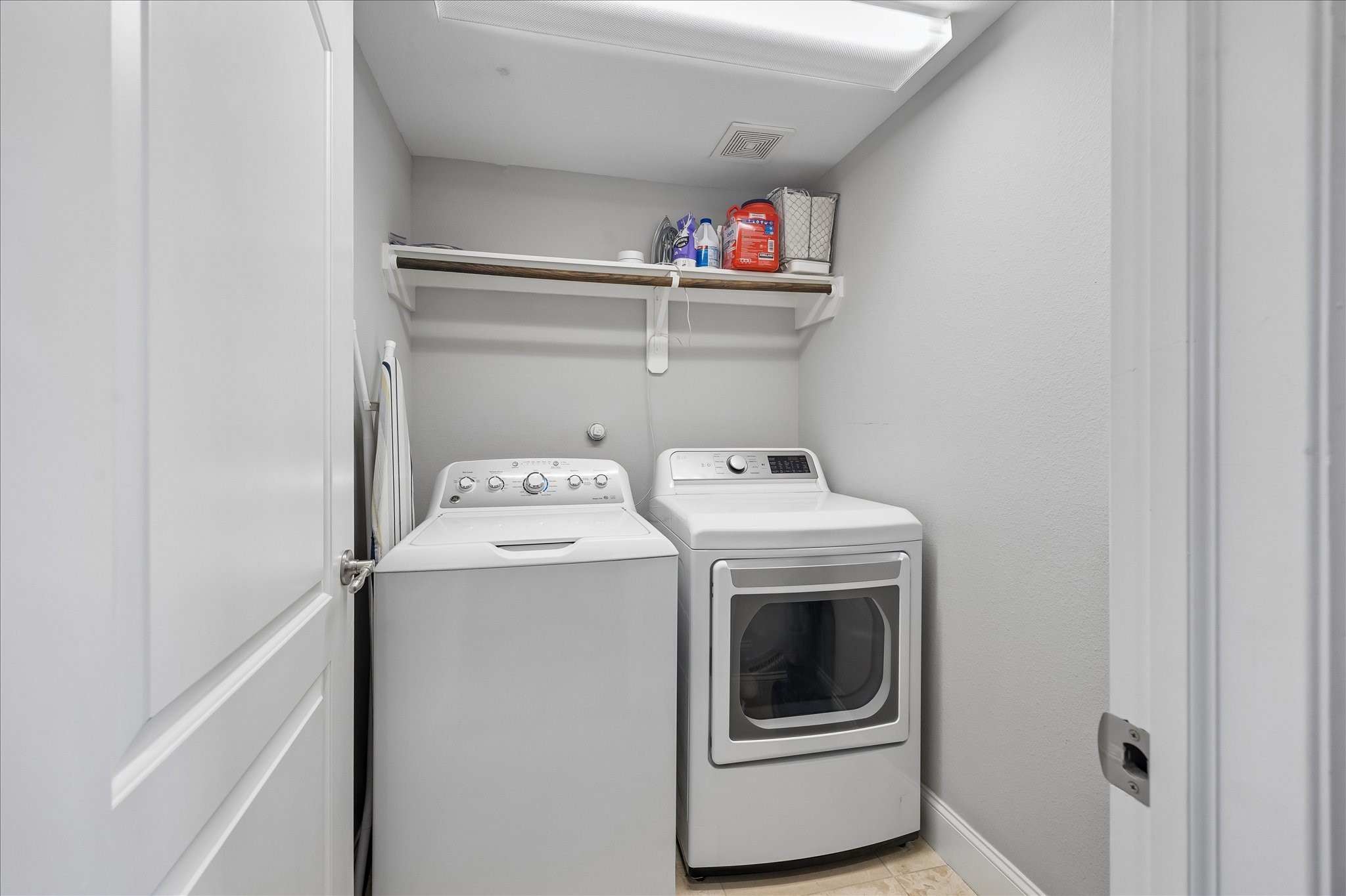 1915 Spring Street Houston, TX 77007 - Photo 26 of 40 True utility room on third level with tile flooring, a storage shelf and hanging space