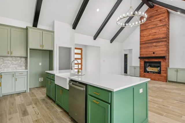 a kitchen with kitchen island a sink stainless steel appliances and cabinets