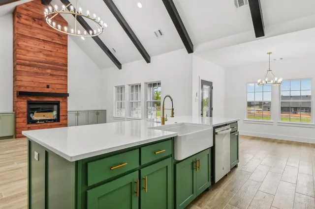 a kitchen with a sink cabinets and wooden floor