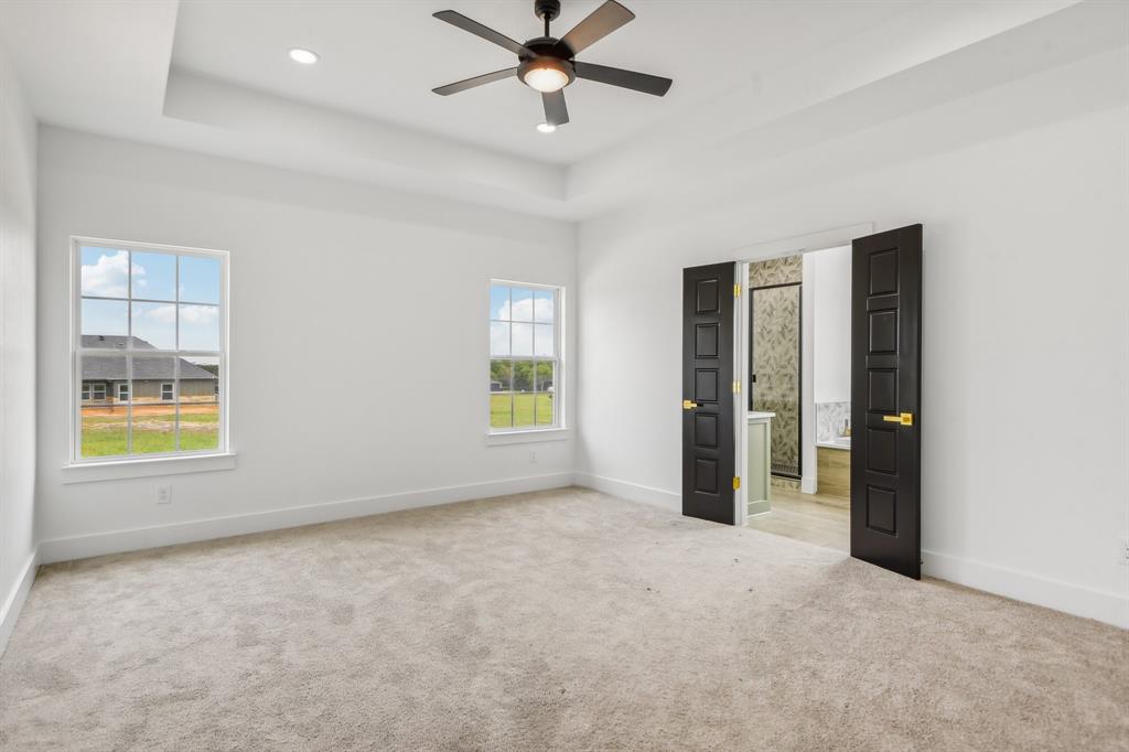 6605 Buffalo Ridge Circle Godley, TX 76044 - Photo 17 of 38 an empty room with windows and fan