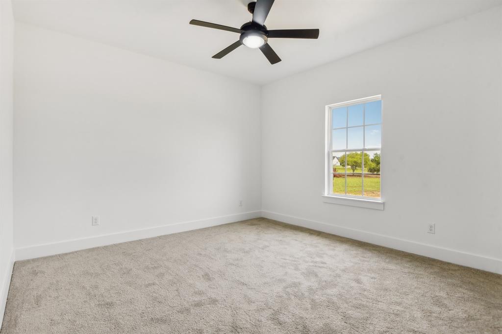 6605 Buffalo Ridge Circle Godley, TX 76044 - Photo 32 of 38 an empty room with a window and ceiling fan