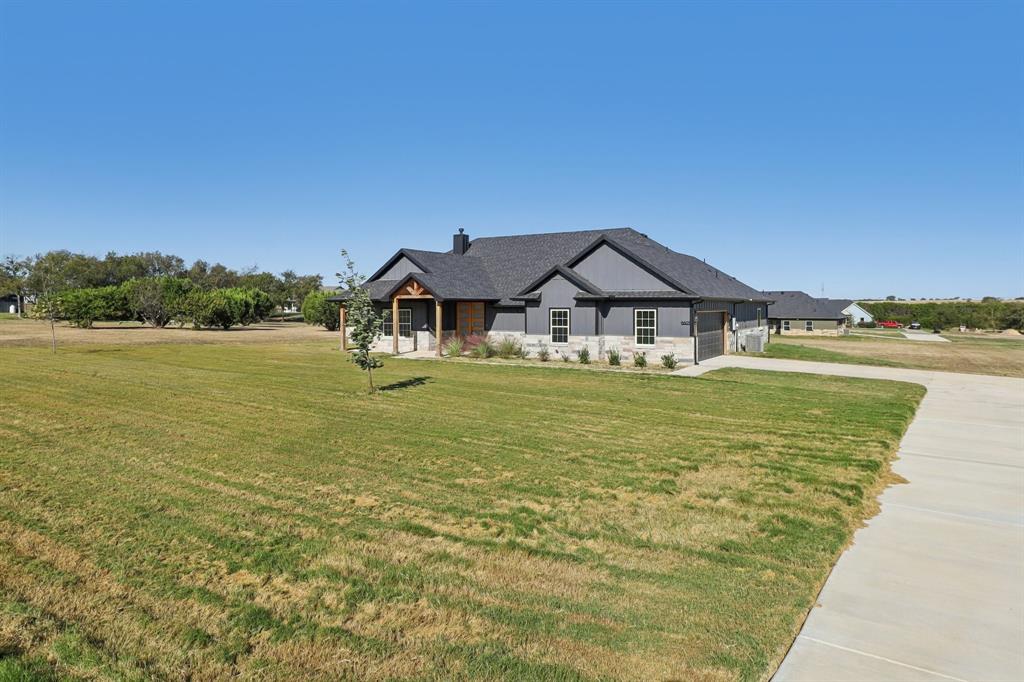 6605 Buffalo Ridge Circle Godley, TX 76044 - Photo 4 of 38 a house with garden in front of it