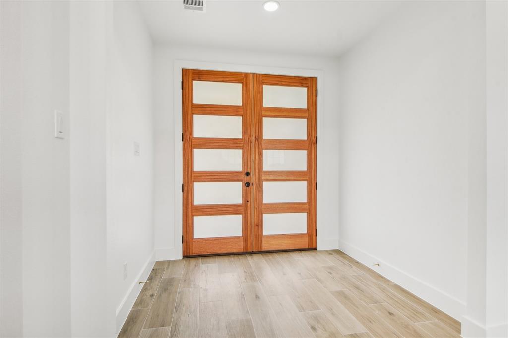 6605 Buffalo Ridge Circle Godley, TX 76044 - Photo 5 of 38 an empty room with wooden floor and windows
