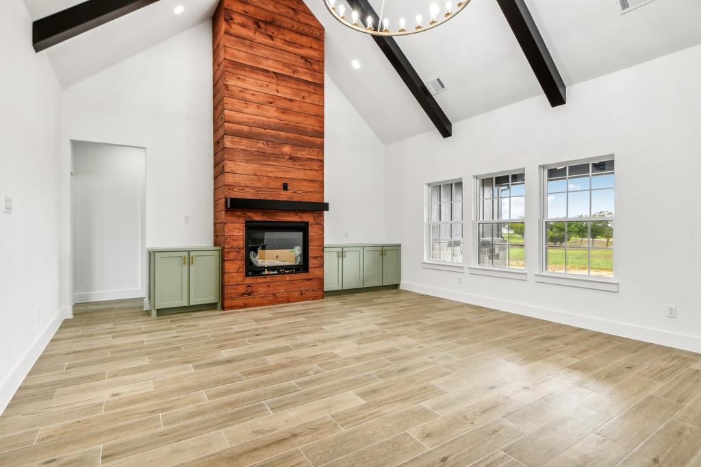 6605 Buffalo Ridge Circle Godley, TX 76044 - Photo 6 of 38 a view of an empty room with wooden floor and a window