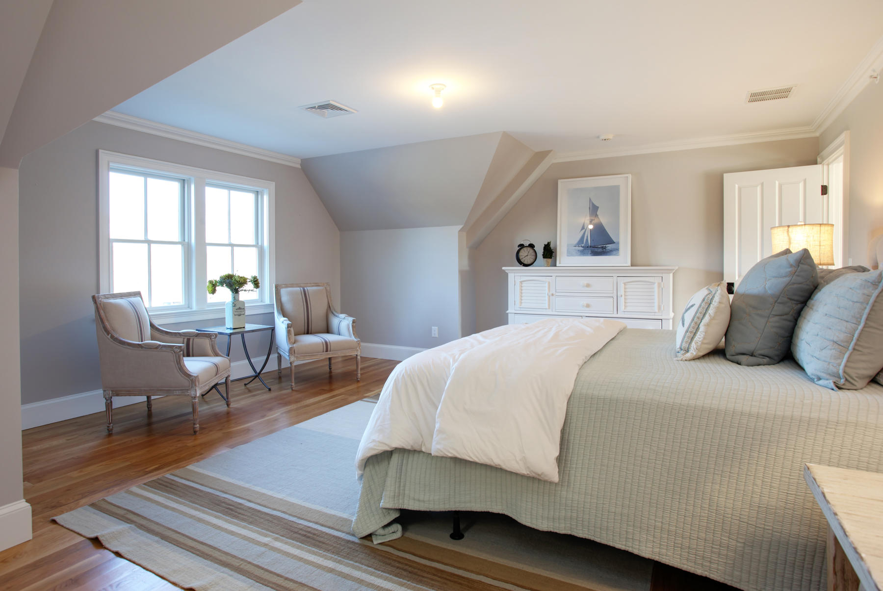 1090 Shore Road, Unit 8 Pocasset, MA 02559 - Photo 16 of 32 a bedroom with a bed a table and chair