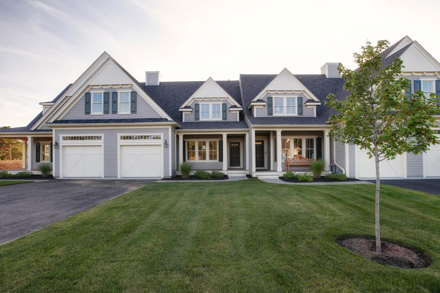 1090 Shore Road, Unit 8 Pocasset, MA 02559 - Photo 22 of 32 a front view of a house with a garden and yard