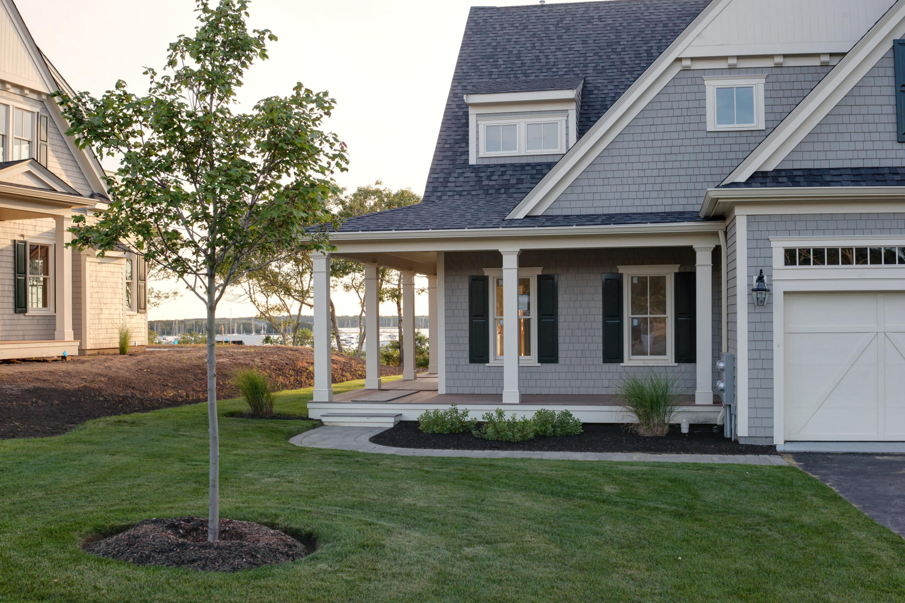 1090 Shore Road, Unit 8 Pocasset, MA 02559 - Photo 24 of 32 a front view of a house with a garden and plants