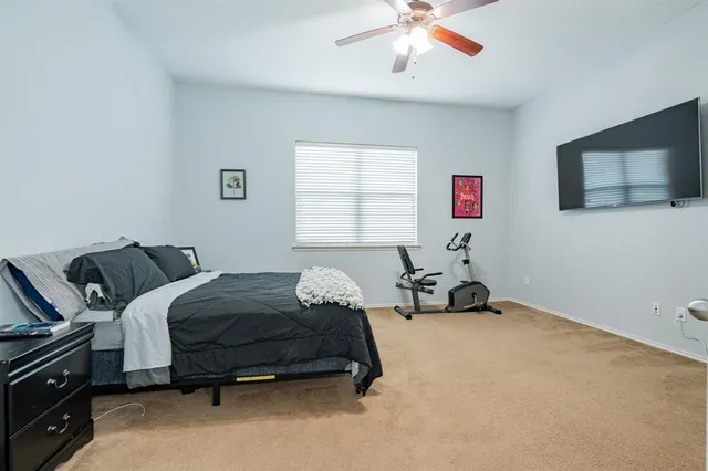 a bedroom with bed and a chandelier