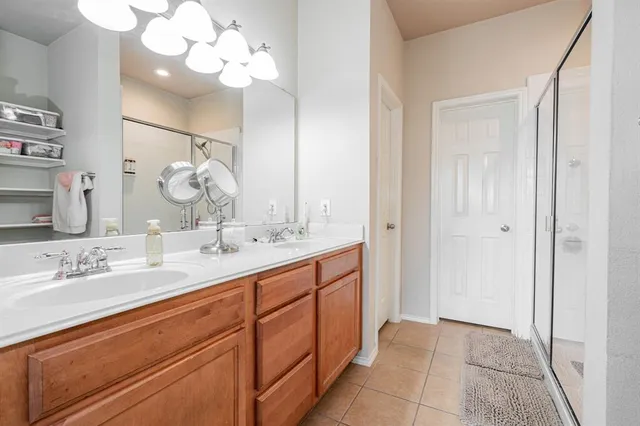 a bathroom with a double vanity sink and a mirror