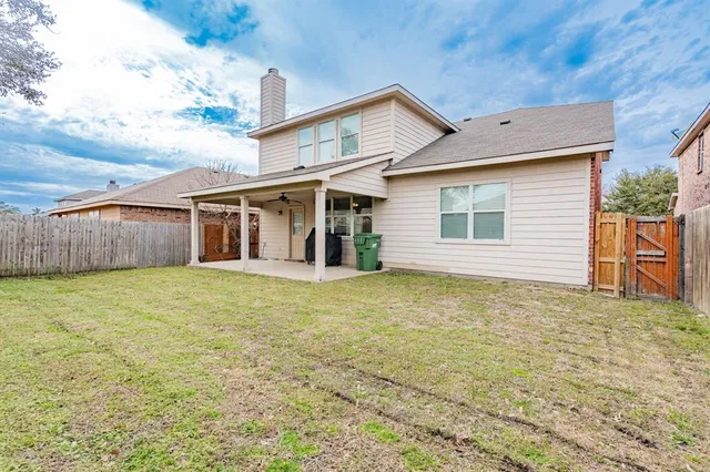 a view of a house with a backyard
