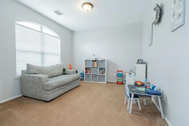 a living room with furniture and a window