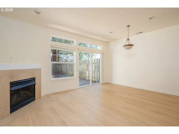 a view of an empty room with glass door and balcony