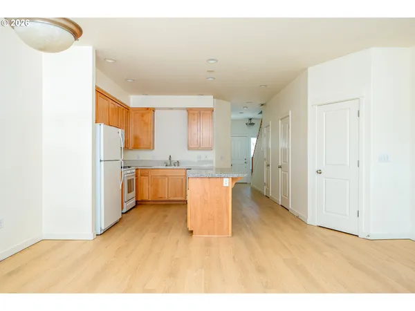 a kitchen with a cabinets and wooden floor