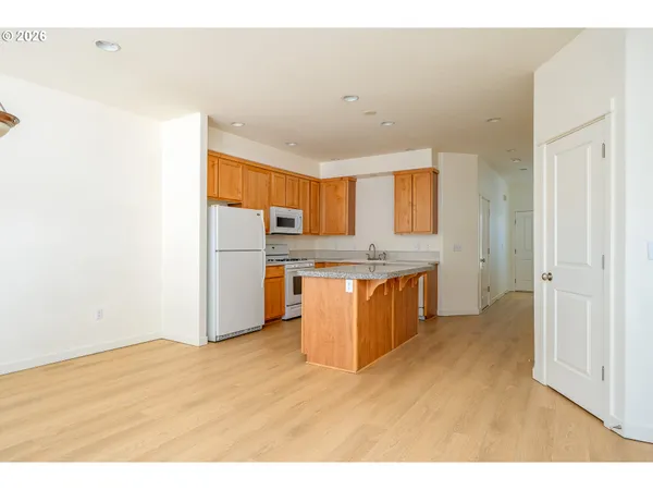 a kitchen with stainless steel appliances a refrigerator and a sink