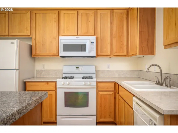 a kitchen with a sink stove and microwave