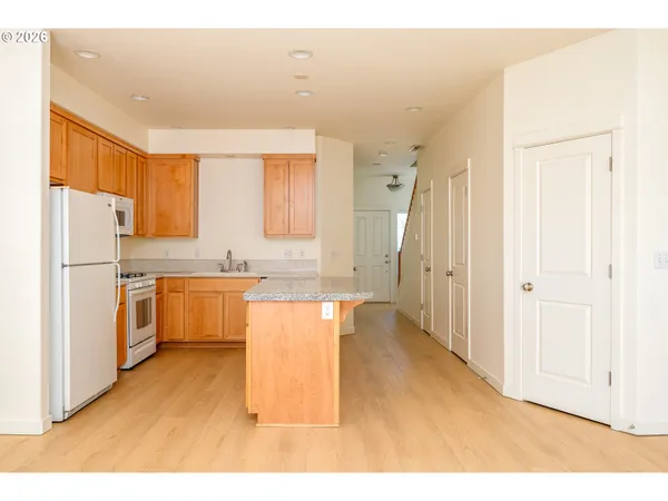 a kitchen with a refrigerator a sink and cabinets