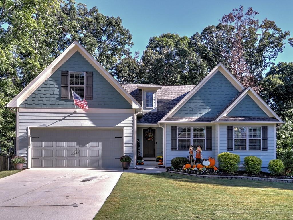 a front view of a house with porch and garden